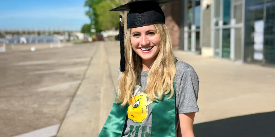 girl wearing a Baylor alumni tshirt and a graduation cap
