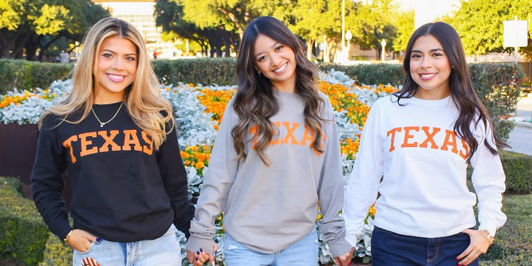3 girls wearing Texas Longhorns crewnecks and long sleeves that read Texas