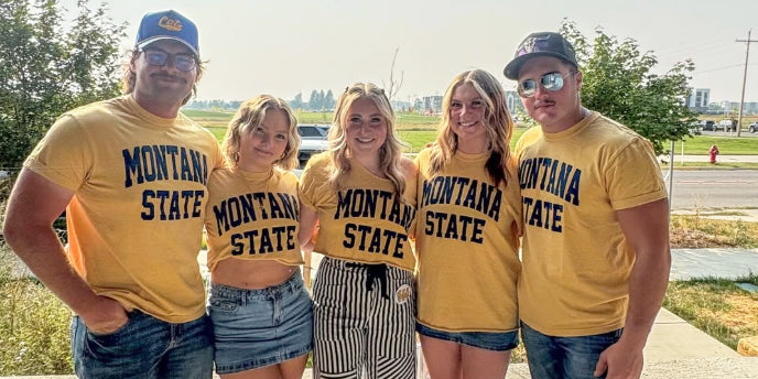 group of people wearing yellow Montana State tshirts