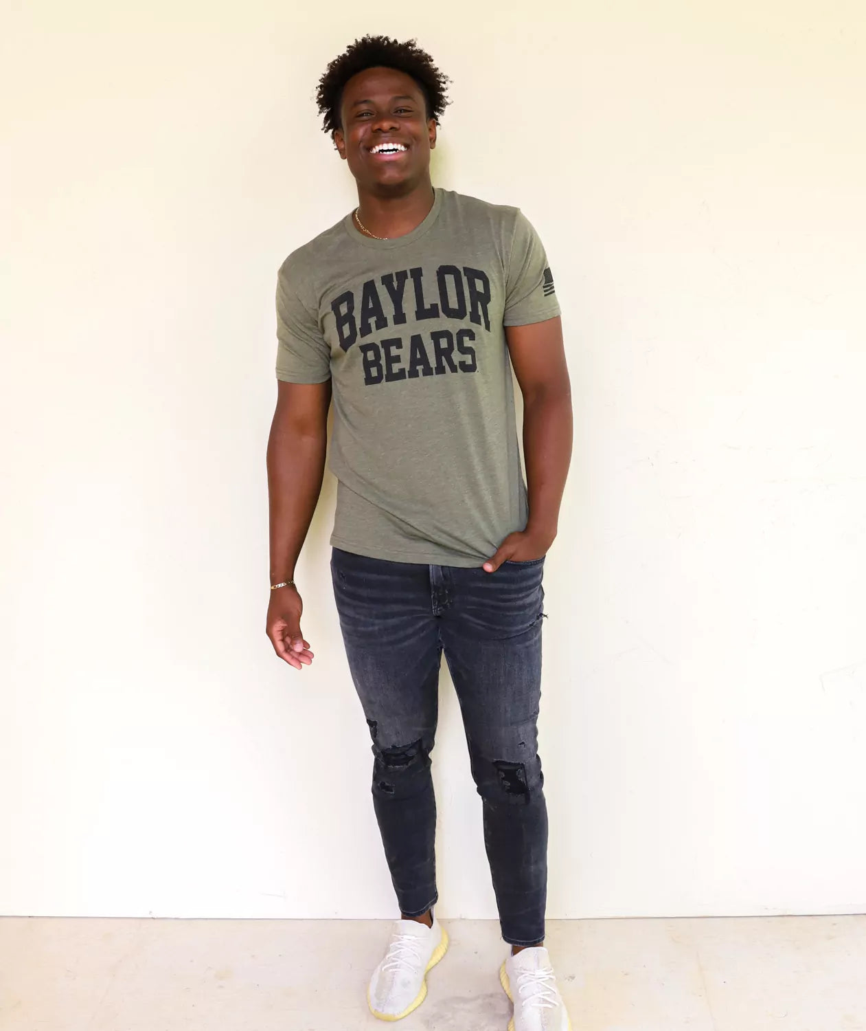 BU Bears student wearing military green Baylor University apparel against a white background.