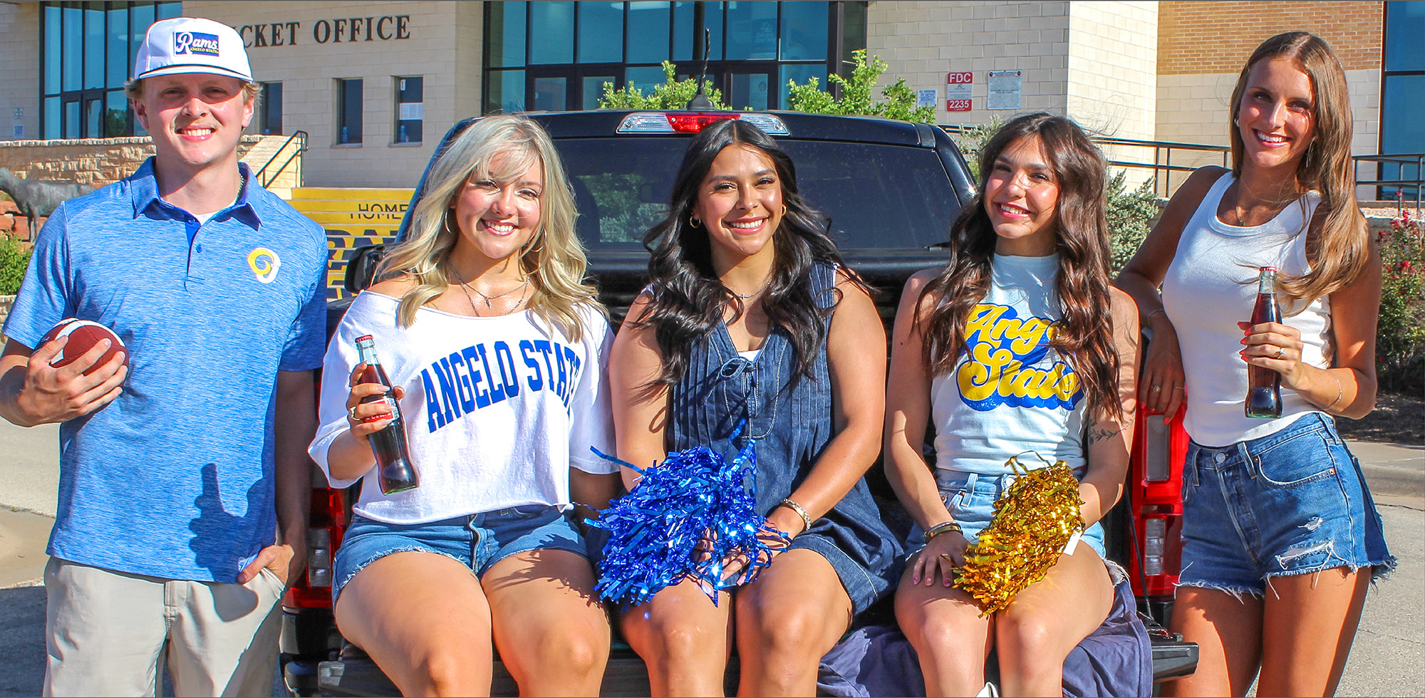 ASU students wearing blue Angelo State University apparel outside a football field
