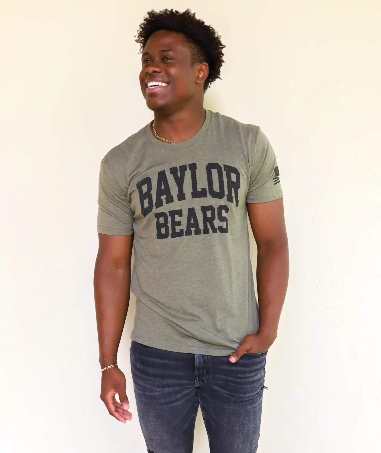 BU Bears student wearing military green Baylor University apparel against a white background.