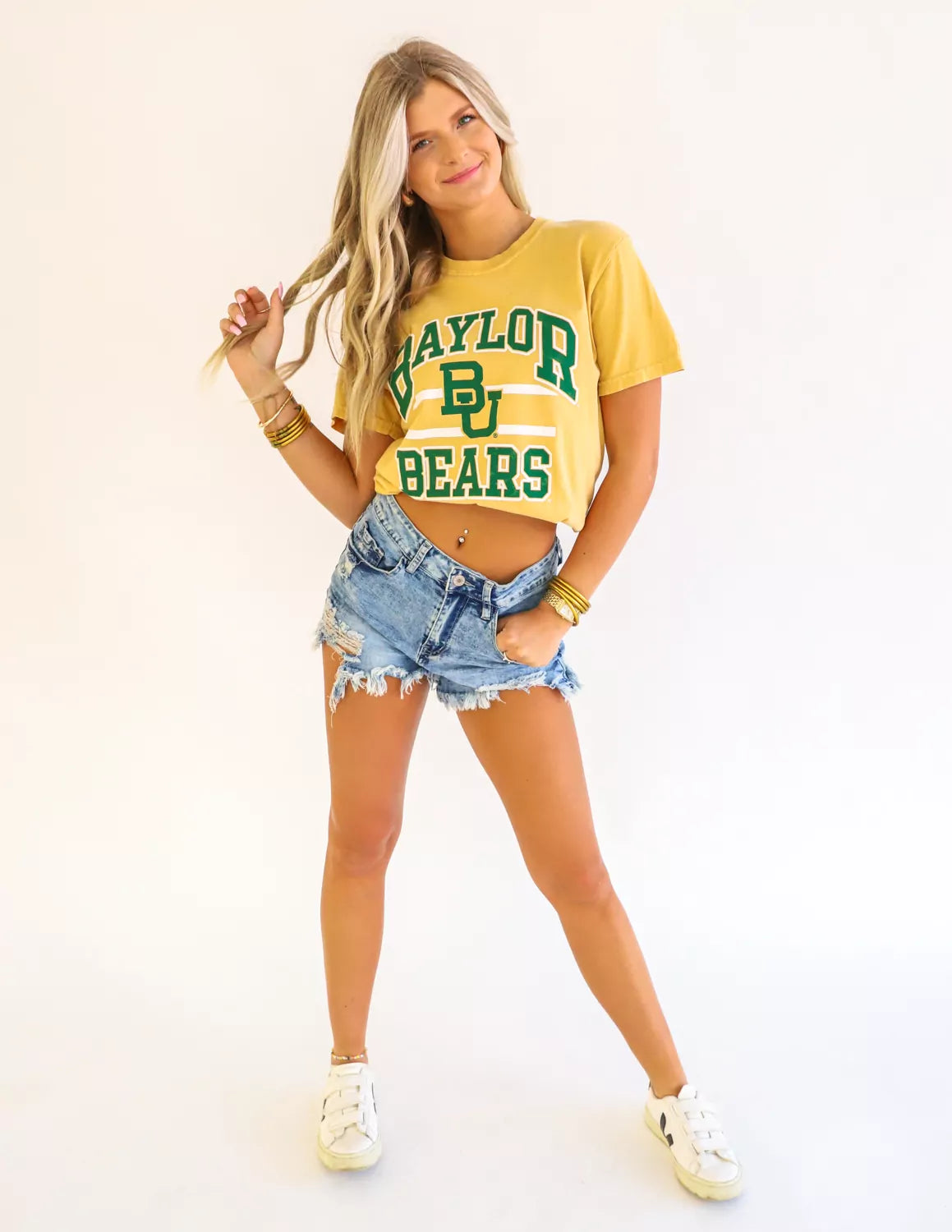 Baylor Bears student wearing mustard Baylor Bears apparel against a white background.