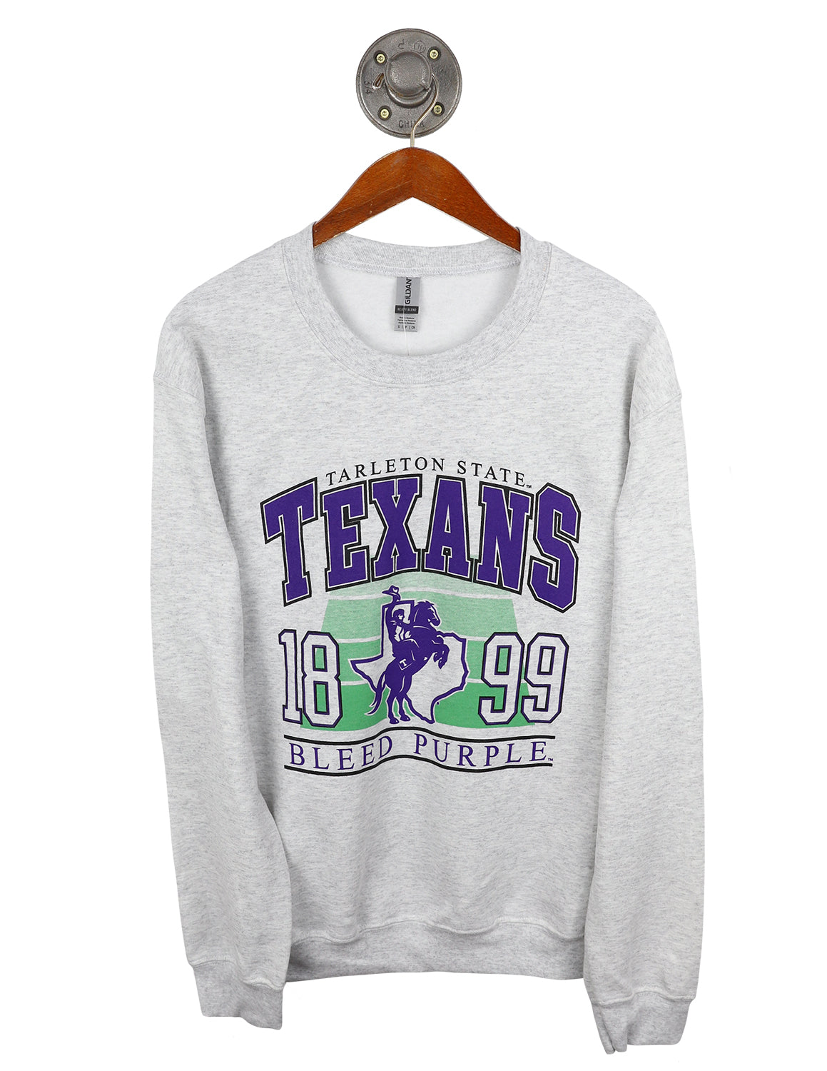 Ash grey unisex Tarleton State University crewneck sweatshirt that features "Texans" purple text with a Texan Rider logo in the middle and a football field graphic in the background.