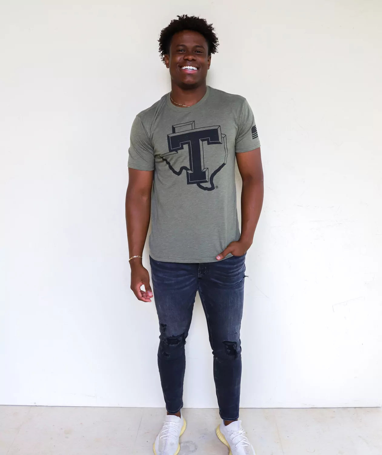 TSU Texans student wearing military green Tarleton State University apparel against a white background.