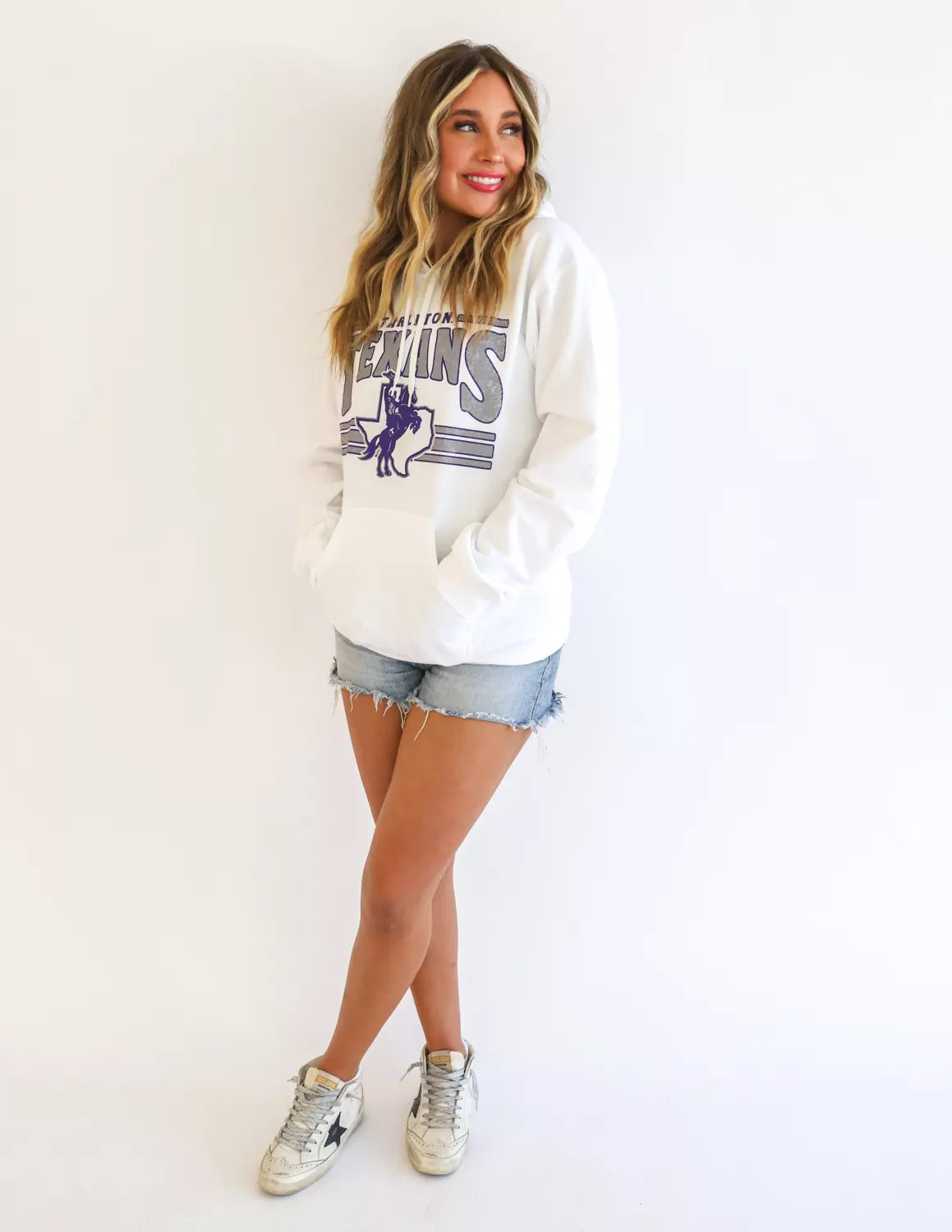 TSU Texan student wearing white Tarleton State University apparel against a white background.