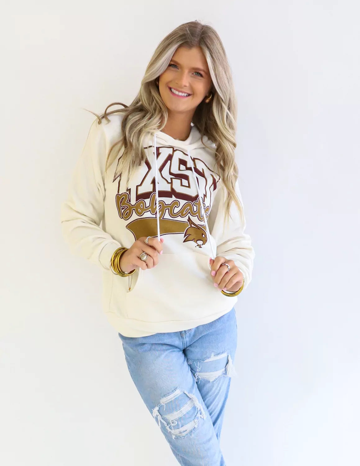 TXST Bobcats student wearing natural Texas State University apparel against a white background.
