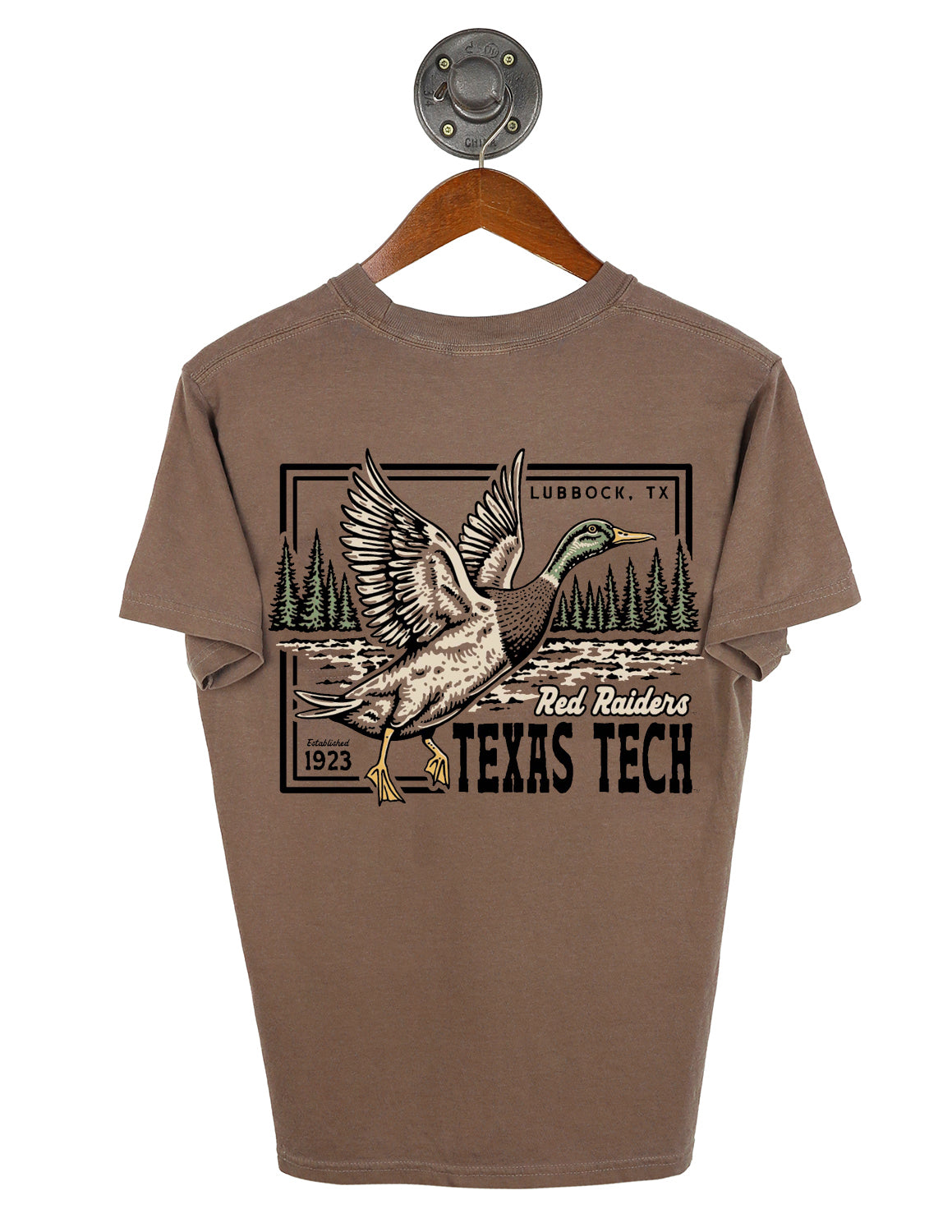 Brown Texas Tec University unisex Comfort Colors t-shirt that features a graphic of a mallard duck in flight over a body of water and pine trees. Throughout the design there is black and white lettering.