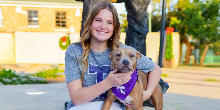 girl and her dog wearing a Tarleton alumni tee