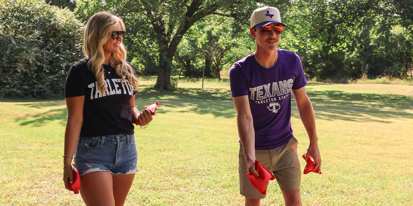 Tarleton students playing cornhole wearing Barefoot tees