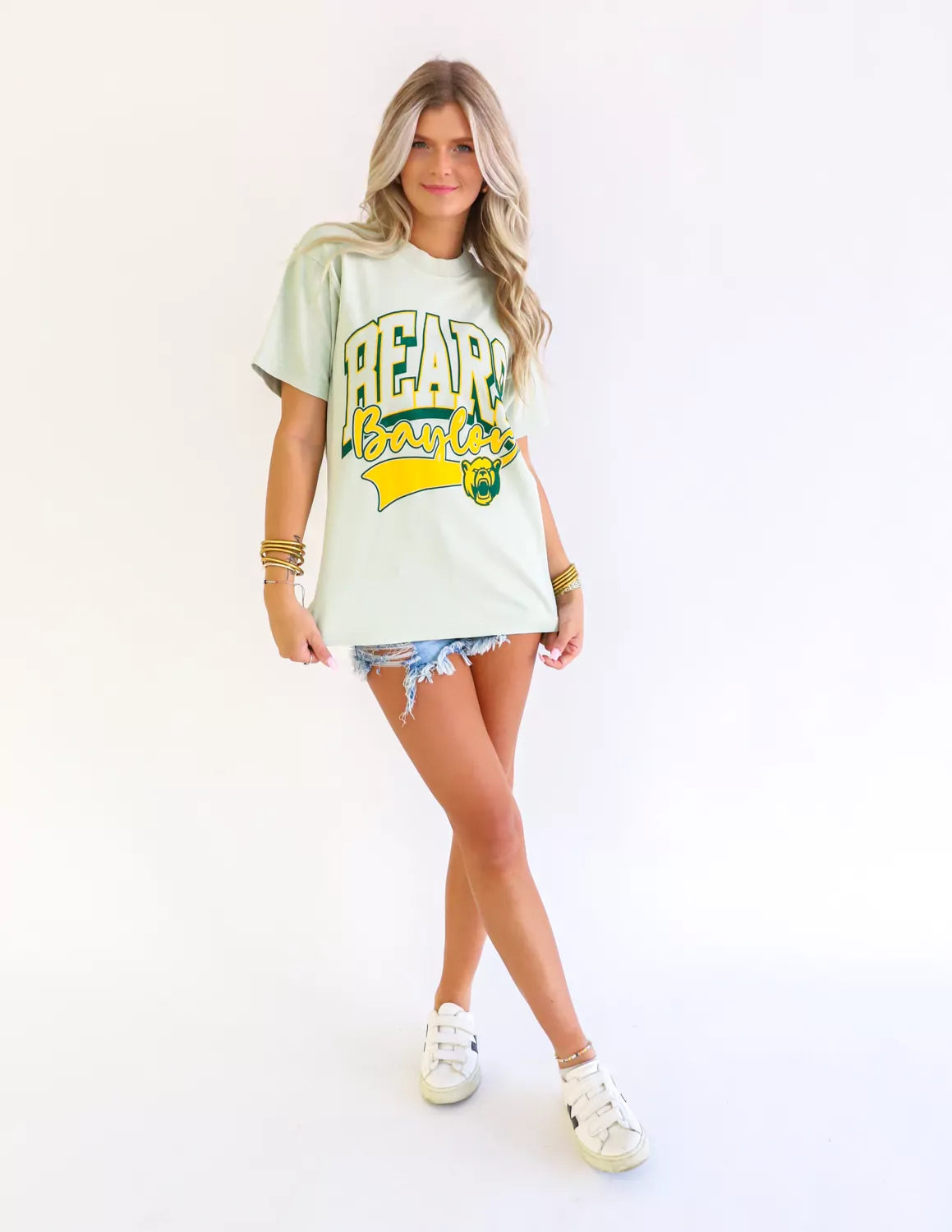 Baylor Bear student wearing pistachio Baylor University apparel against a white background. 