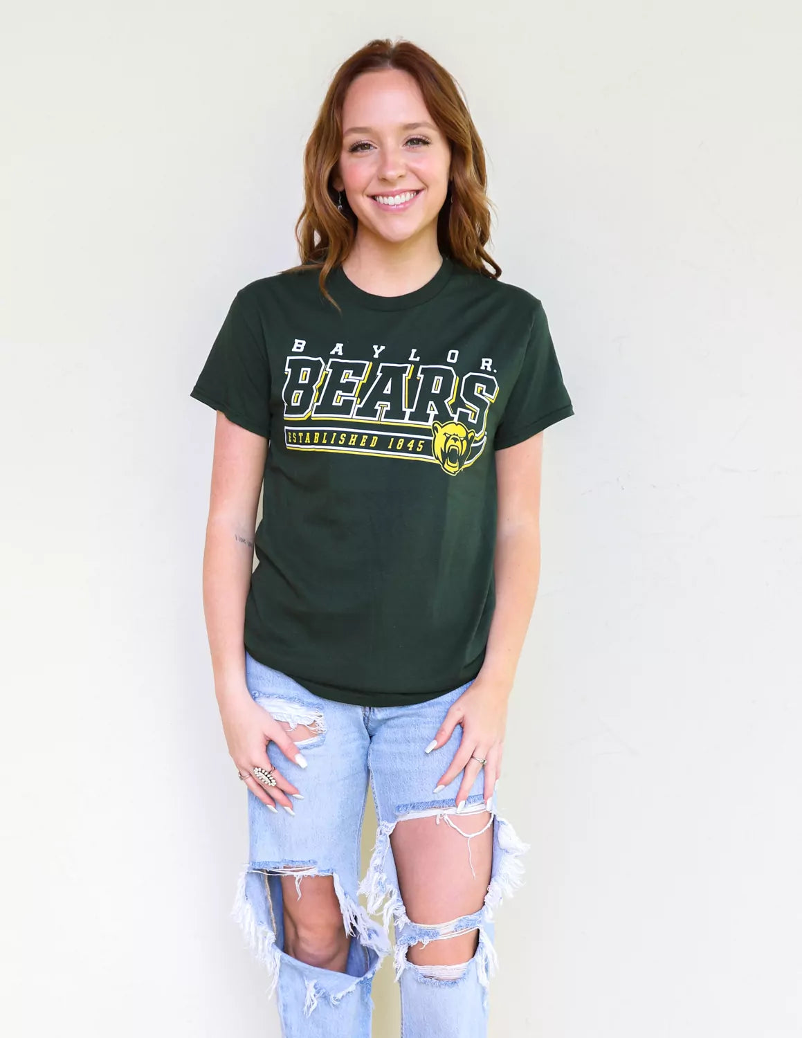 BU Bears student wearing forest green Baylor University apparel against a white background. 