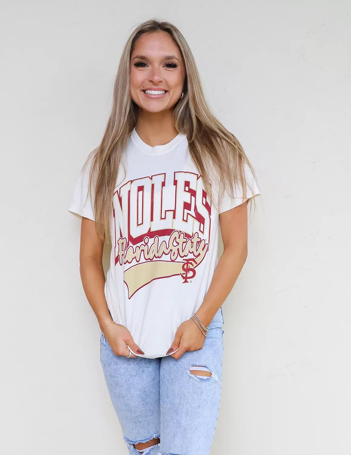 FSU Seminoles student wearing white Florida State University apparel against a white background. 
