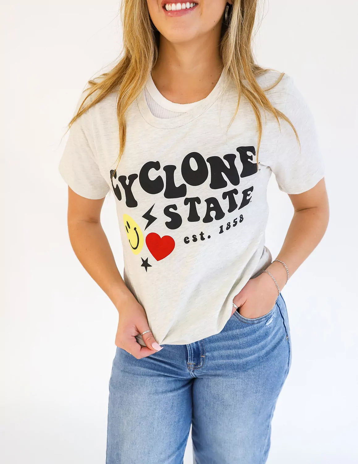 Close-up of an Iowa State University student wearing cream heather ISU apparel against a white background. 