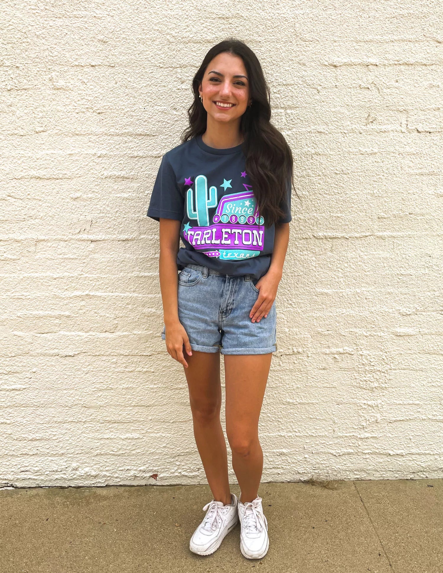 TSU Texans student wearing navy Tarleton State University apparel outside. 