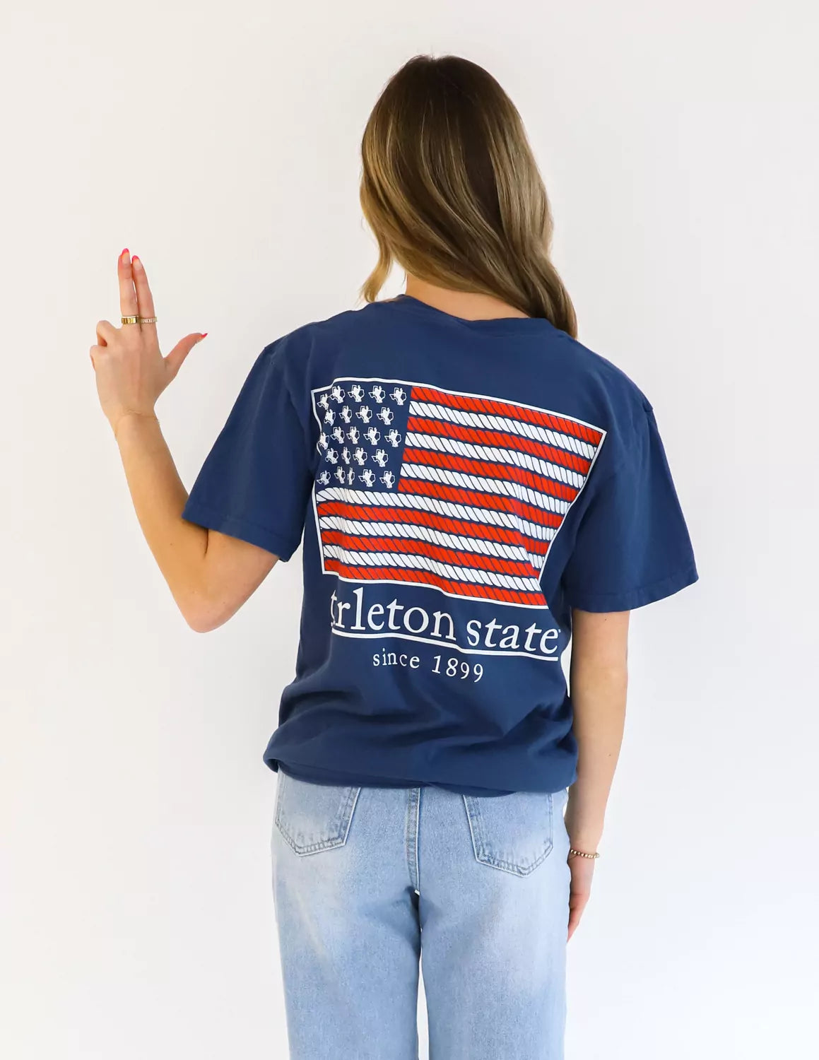 Tarleton State University student wearing blue TSU apparel against a white background. 