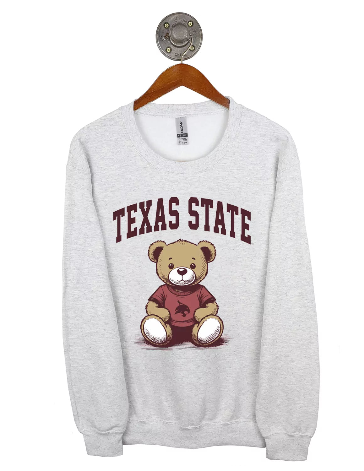 Ash grey Texas State University Gildan unisex crewneck sweatshirt featuring a teddy bear and maroon lettering. 