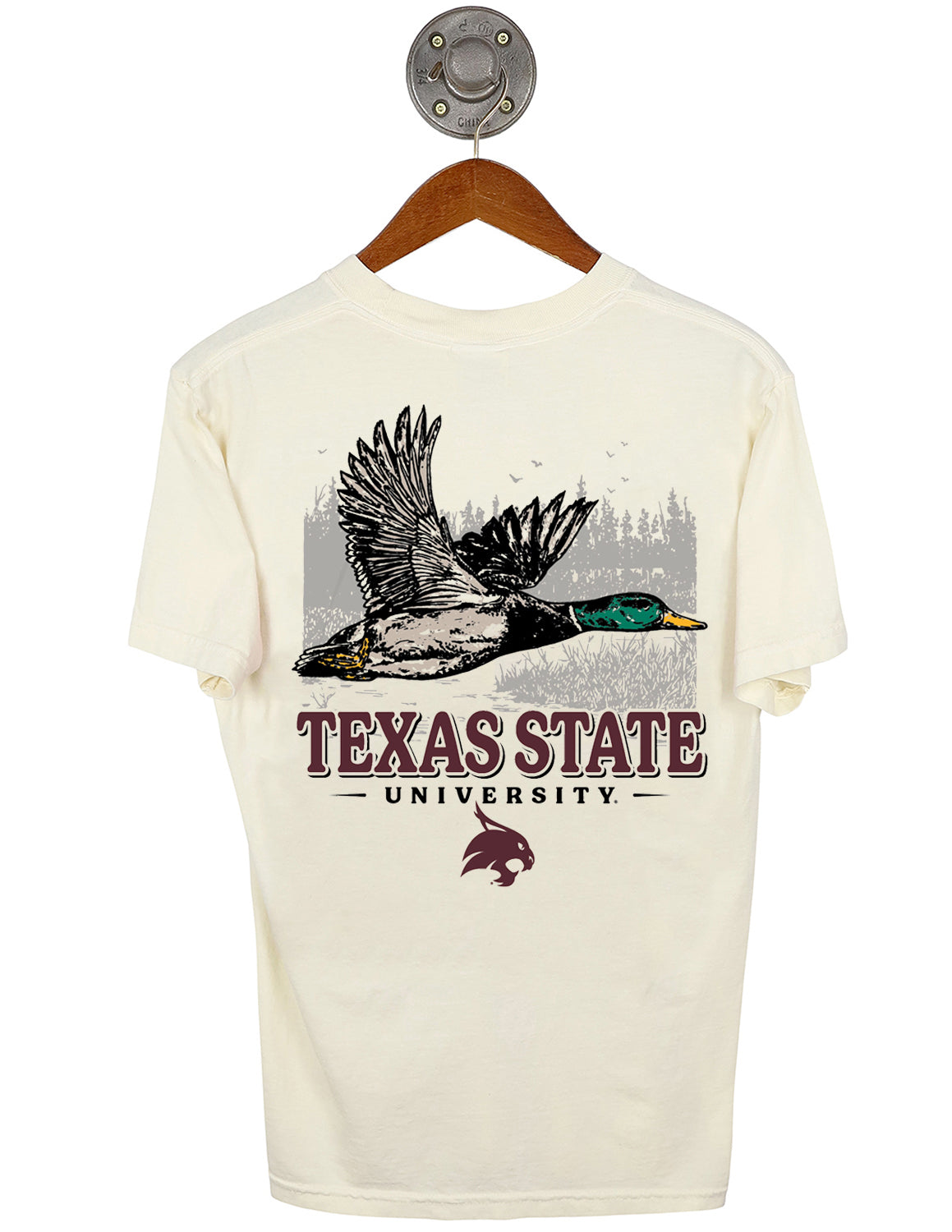 Back-view of ivory Texas State University unisex short-sleeve t-shirt that features a mallard duck flying against a marshy landscape graphic with maroon and black lettering underneath.
